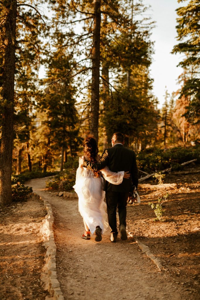 Bride & Groom hiking to their sunrise elopement ceremony location in Bryce Canyon National Park
